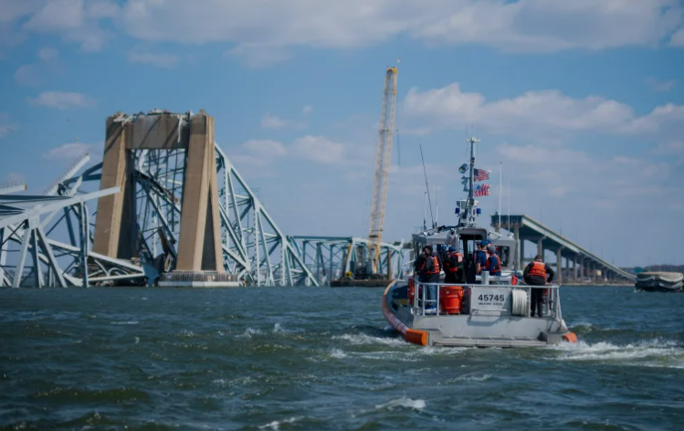 A boat navigates the aftermath of the bridge tragedy.